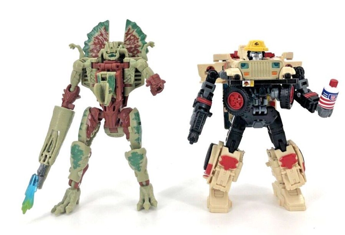 Dilophocon & Autobot JP12 In-Hand Images from Transformers X Jurassic Park Set